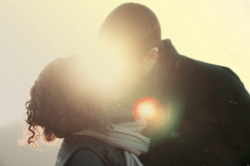 young-couple-kissing-in-sun